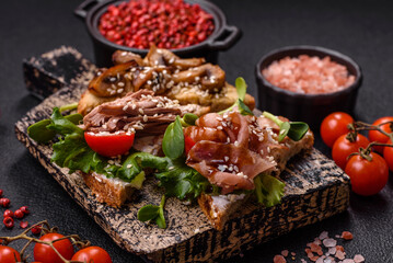 Variation of several toasts or bruschetta with prosciutto, mushrooms and veal