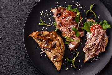 Variation of several toasts or bruschetta with prosciutto, mushrooms and veal