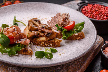 Variation of several toasts or bruschetta with prosciutto, mushrooms and veal