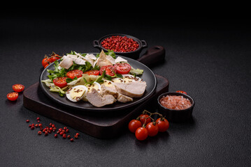 Delicious fresh caesar salad in a bowl with chicken breast, egg, tomatoes