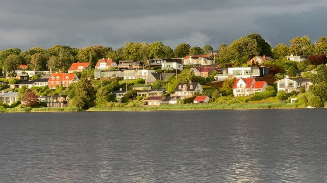 Villas on a shore of Viborg lake, Denmark, Jutland, Exterior, Colorful houses by the small fishing port, Old timbered house in , Denmark. video taken in public park.