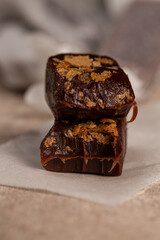 Handmade toffee, bitter chocolate with waffle, close-up