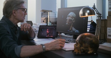 Mature scientist or researcher studies fossil skull, uses tablet and computer with 3D visualization...