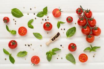 Fresh tomatoes, basil, sea salt and spices on wooden background, top view