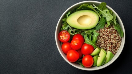 A vibrant bowl of healthy salad featuring fresh avocado, cherry tomatoes, quinoa, and leafy greens, perfect for nutritious meals.