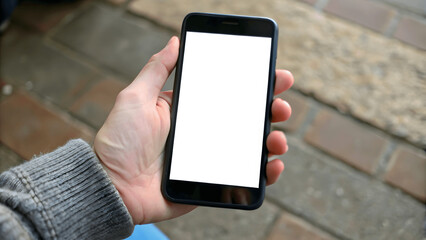 A close-up of hands holding a smartphone with a blank screen
