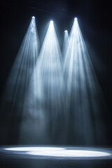 Bright spotlights beam down on an empty stage, their powerful light cutting through the darkness