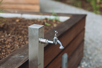 Water source in city park on the street. Modern Drinking fountain. Garden Tap Outside for Garden Hose.