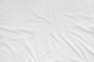 Top view of wrinkles on an unmade bed sheet after waking up in the morning.