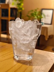 Glass with ice cube on wooden table in restaurant. Beverage menu. Cold drink