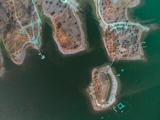 Aerial view of Mourão river beach in Alentejo, Portugal. Nestled by the Alqueva reservoir, it offers sandy shores, tranquil waters, and scenic beauty, ideal for relaxation and outdoor activities.