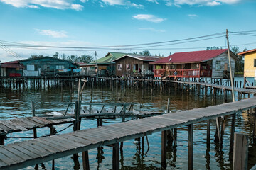 Fishing village houses over the water garbage poor areas in Sabah province in Malaysia