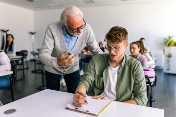 Senior teacher explaining a lesson to one of his students.