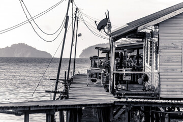 Fishing village houses over the water garbage poor areas in Sabah province in Malaysia