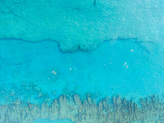 Aerial drone shot of the blue turquoise sea reef