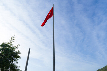 Turkish flag on a pole under the blue sky