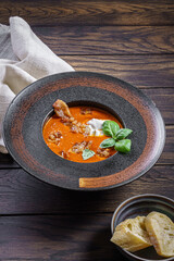 Tomato soup with crispy bacon with dollop of creamy mascarpone and basil