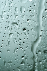Abstract background, selective focus. Raindrops on glass. Spray on the window. Rainy weather