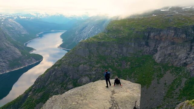 PEOPLE AT THE TONGUE OF THE CLIFF TROLLTUNGA NORWAY 4K AREAL