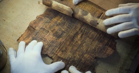 Scientists study cultural heritage of extinct human civilization. Two archaeologists in gloves...