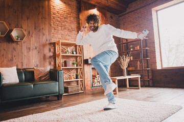Fototapeta premium Photo of funky cool guy dressed white pullover headphones relaxing home having fun indoors house apartment room
