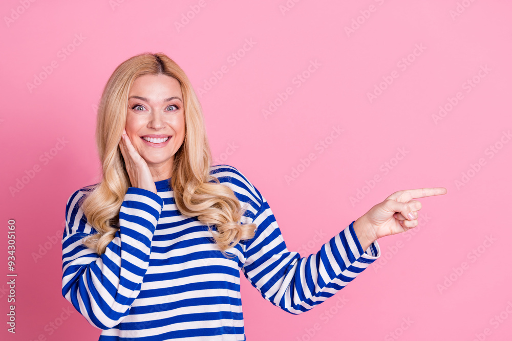 Wall mural photo of cheerful glad nice woman wear stylish striped clothes introduce empty space isolated on pin