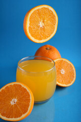 photo, glass, orange, juice, drink, whole, half, composition, decorated, bright, blue, ripe, background, citrus, juicy, mid, air, photography