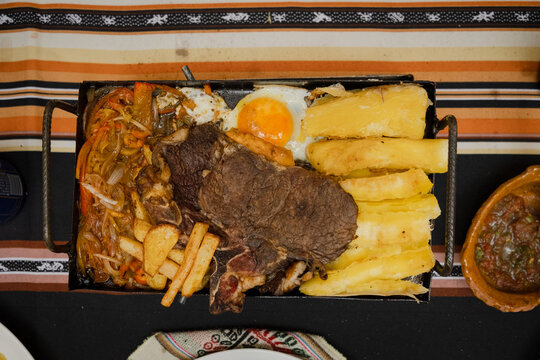 traditional bolivian food from cochabamba called planchitas con carne asada y huevo - traditional food concept