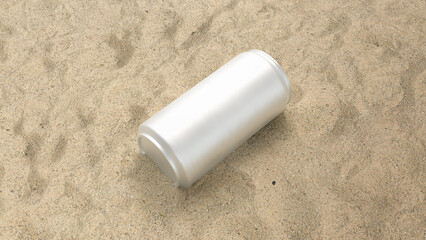 a white metal aluminum soda can on the sand at the beach