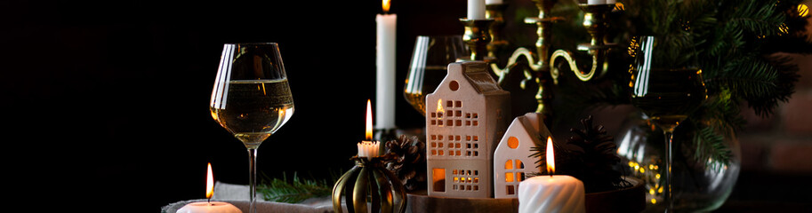 Banner. Elegant decor for Christmas family dinner. Center piece with burning candles, vintage chandelier. Zero waste eco-friendly home decoration, fir tree branches. Cozy atmosphere, wooden furniture