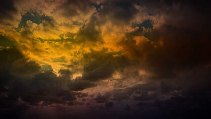 Dark golden clouds merge with hints of green and orange, creating a dramatic 4K background perfect for atmospheric wallpapers, banners, and natural backdrops