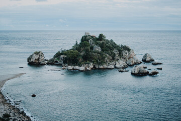 Famous Italian island called Isola Bella in Taormina, on Sicily. Calm cloudy evening right after sunset.