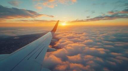 Sunrise view from an airplane window above the clouds during early morning flight