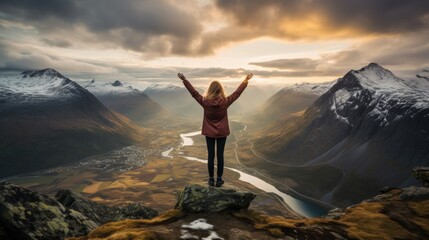 Fototapeta premium Empowered female superhero triumphantly standing at the summit of a challenging mountain