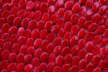 Obraz premium Pumpkin seeds arranged evenly and painted red. Background. Texture.