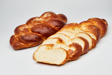 Braided sweet bread loaf sliced, showcasing its golden crust and soft, fluffy interior