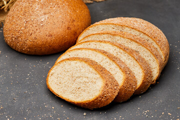Whole wheat bread loaf sliced, showcasing its hearty texture and rich, wholesome flavor