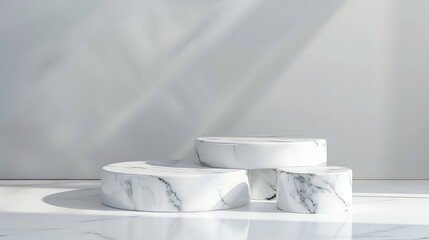 Three white marble podiums on a white marble surface with shadows from the window.
