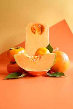 Orange fruit and vegetables with orange polka dot tableware, color blocking aesthetic. Orange foods contain beta carotene, an antioxidant that helps reduce inflammation in the body.