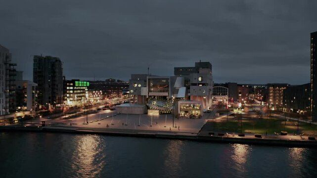 Evening cityscape of the illuminated Aalborg, North Jutland Region (Nordjylland), Denmark. Famous landmark - House of Music (Musikkens Hus) is in the center
