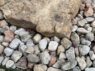 Subtle background element in nature with stone wall texture, big and small rocks,  gray to soft brown on ground. . 