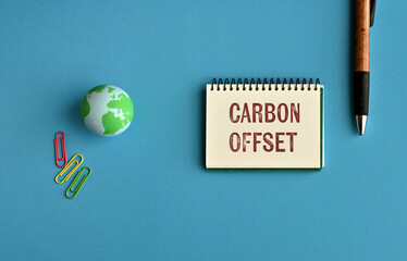There is notebook with the word Carbon Offset. It is as an eye-catching image.