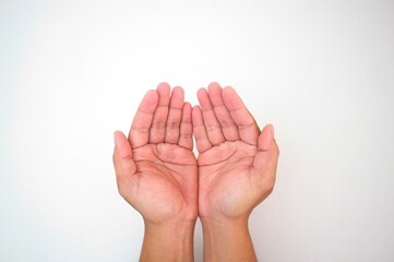 Two human hands held side by side, palms open and cupped upwards, against a plain white background,...