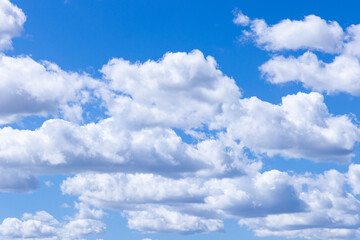 Portugal, Evora. White clouds floating in a blue sky.