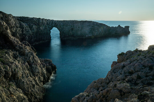 Spain, Menorca. Sunset at Pont d'En Gil (natural arch).