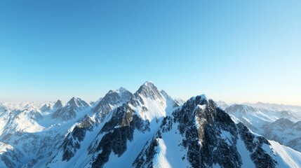 Fototapeta premium Majestic mountain range with snow-capped peaks and clear blue sky above. Majestic Mountain Range