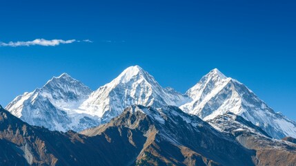 Majestic mountain range with snow-capped peaks and clear blue sky above. Majestic Mountain Range