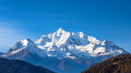 Majestic mountain range with snow-capped peaks and clear blue sky above. Majestic Mountain Range