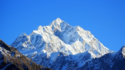 Majestic mountain range with snow-capped peaks and clear blue sky above. Majestic Mountain Range