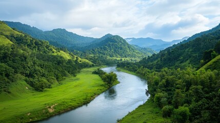 Fototapeta premium A peaceful valley surrounded by lush green mountains and gentle river flowing through it. Serene Mountain Valley
